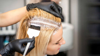 Bleached blonde hair being repaired with Kostume K. Fiber post-bleach treatments