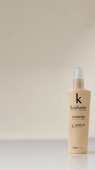 A 300ml bottle of Kostume Purifier Leave In hair spray, shown on a clean, light beige background with a subtle reflection.
