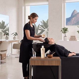 A certified Kostume stylist applying Purifier Micellar Liquid Mask section by section in a salon